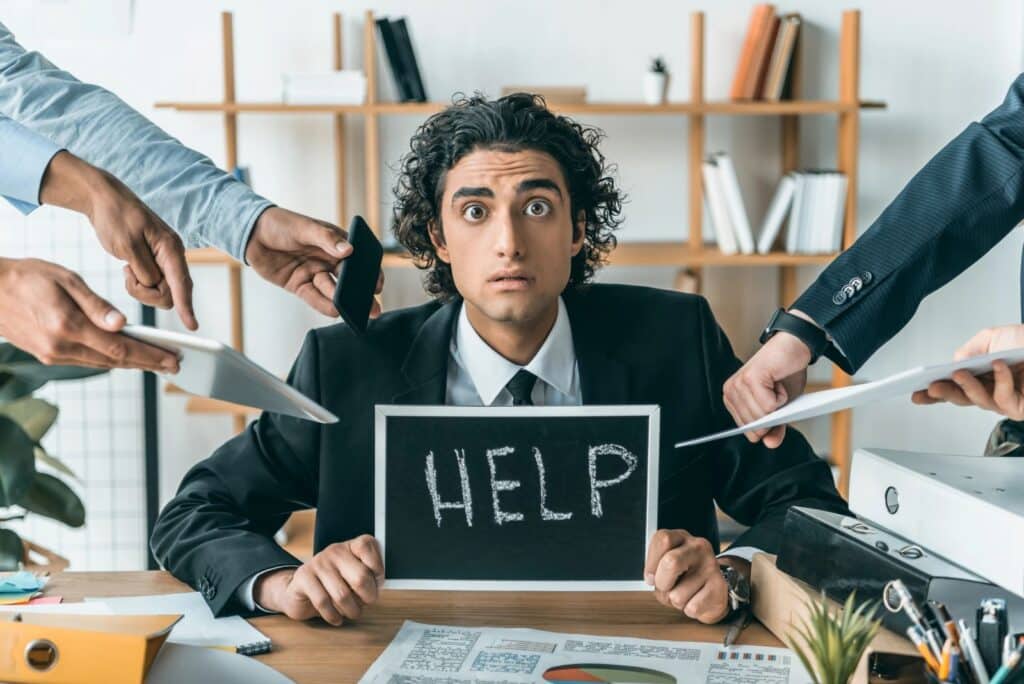 man holding help sign burnt out at work